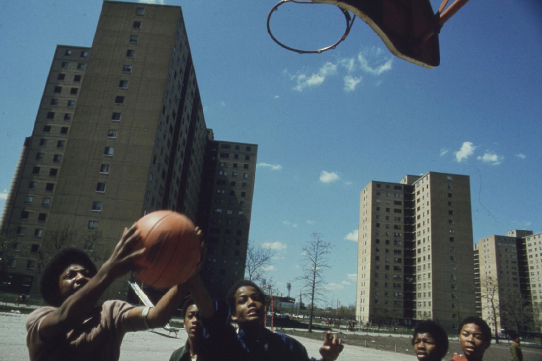 Black youths play basketball at Stateway Gardens' highrise housing project on Chicago's South Side.