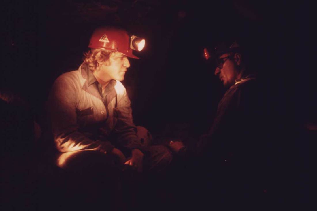 Veteran Miner Harold Stanley (right), talks to a young miner who has come into the mine for the first time after 40 hours of classroom training, April 1974